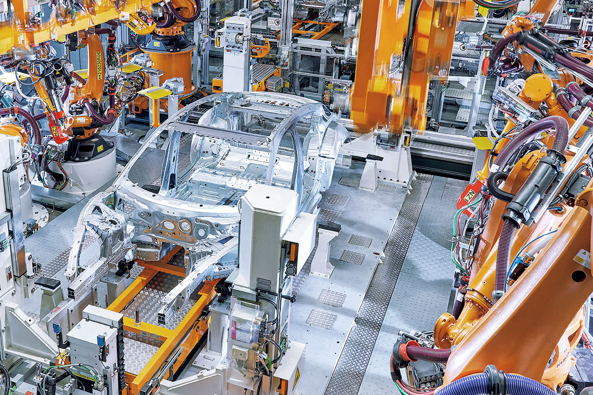 High-angle shot of a piece of the Audi e-tron GT body inside the crucial two-way framer machine. 