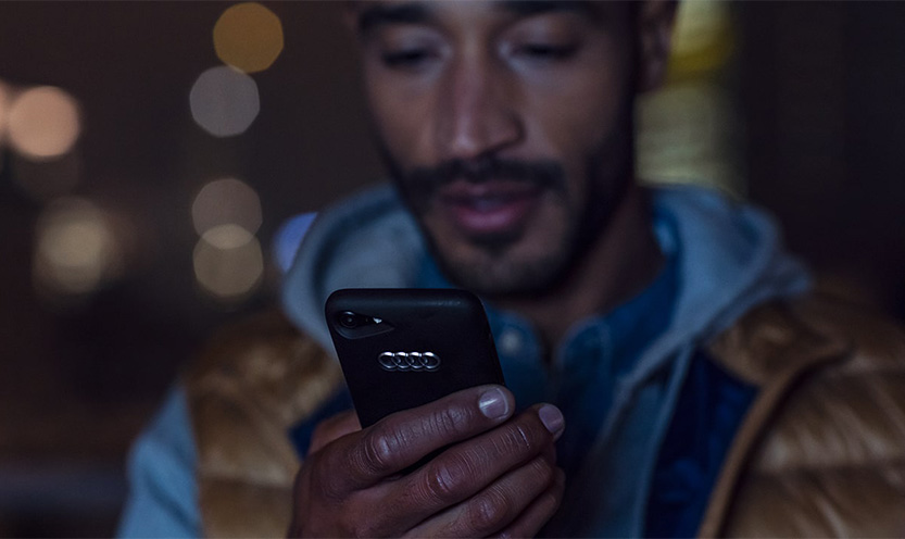 Photo of a man looking at his mobile phone.